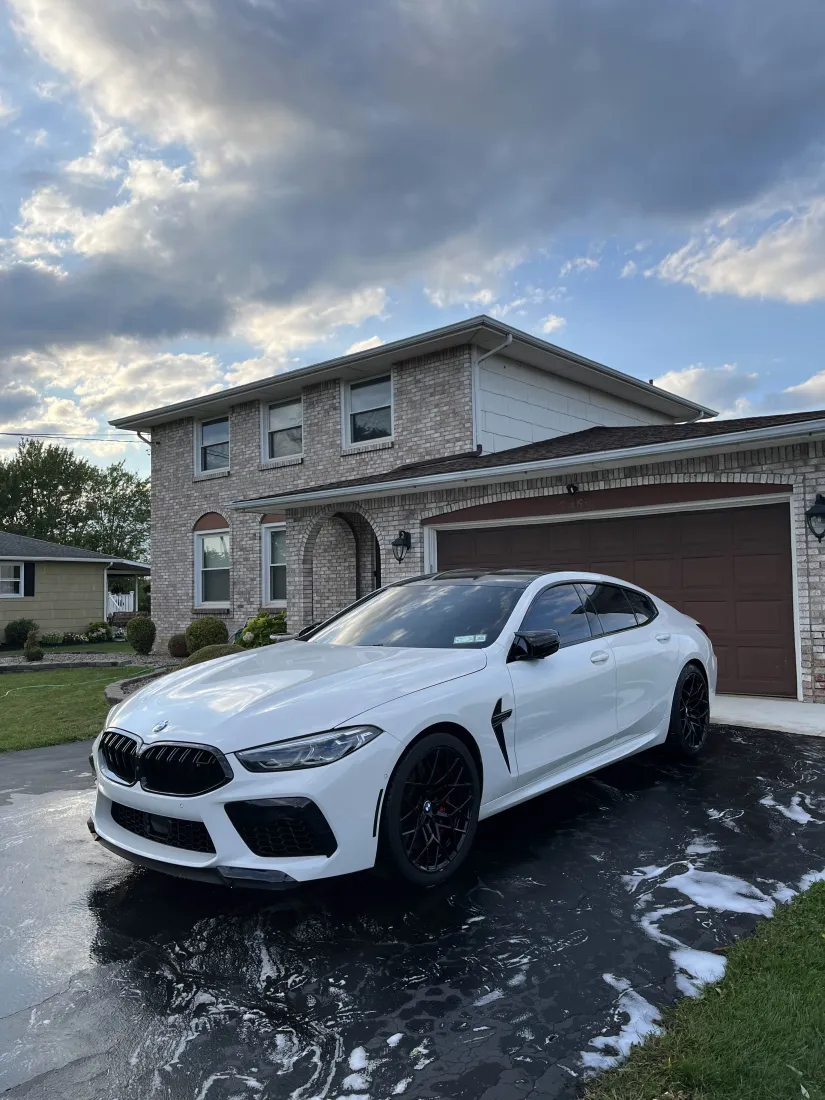 White BMW M8 Gran Coupe with mirror-finish paint after professional detailing