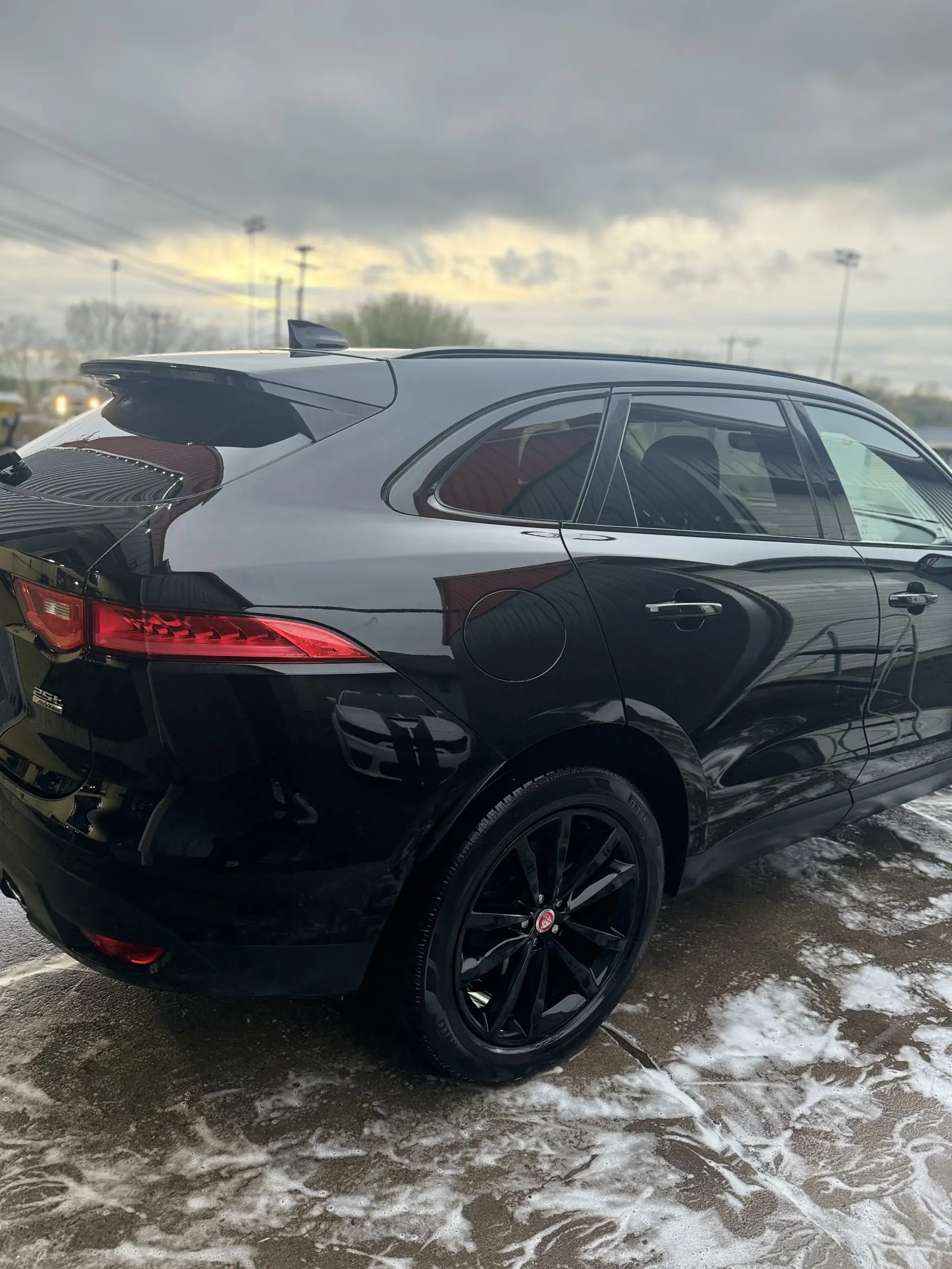 Black Jaguar F-PACE side view showcasing professional exterior detailing