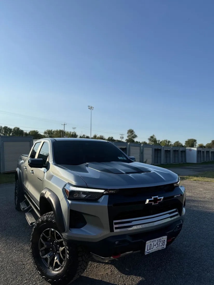 Gray Chevrolet Colorado ZR2 showcasing ceramic window tint at golden hour
