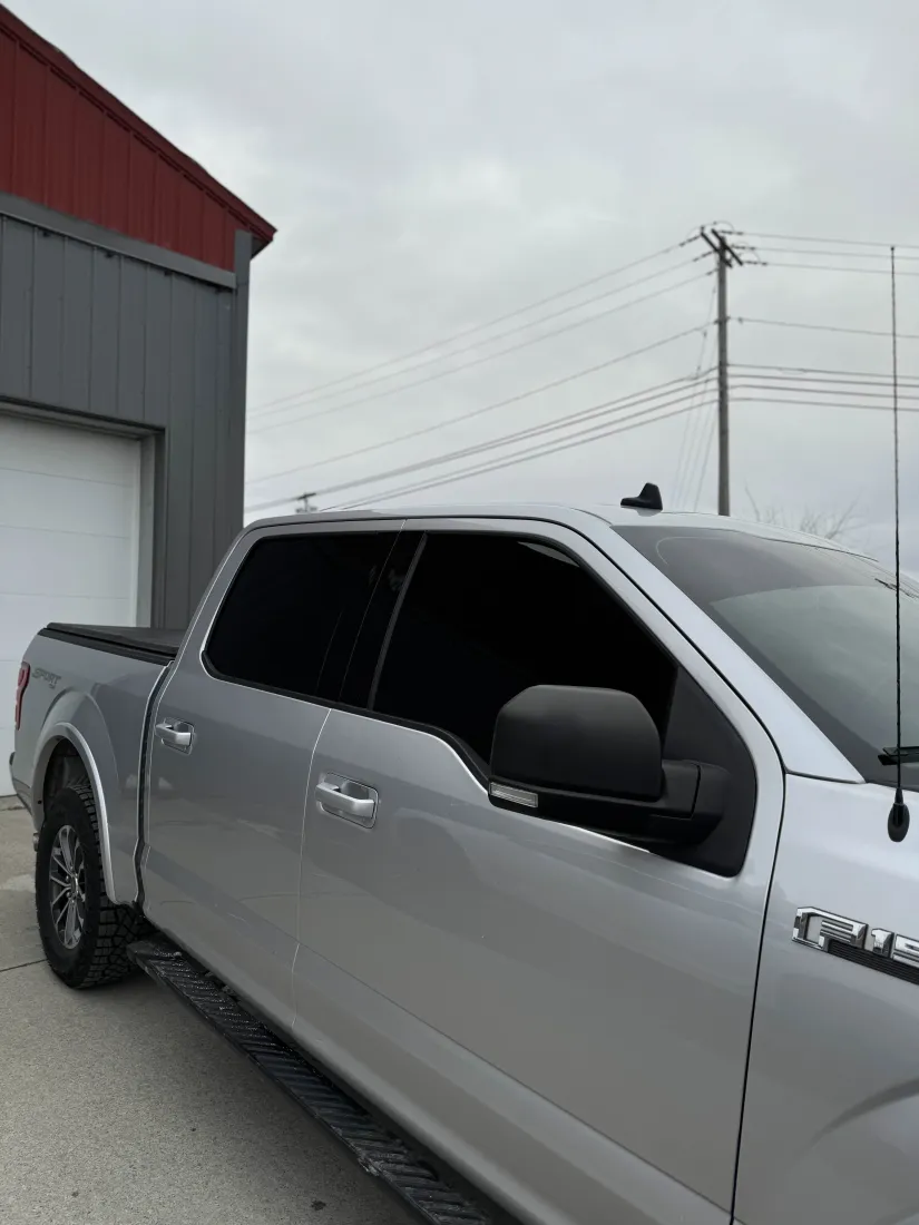 Silver Ford F-150 with dark limo tint showcasing contrast