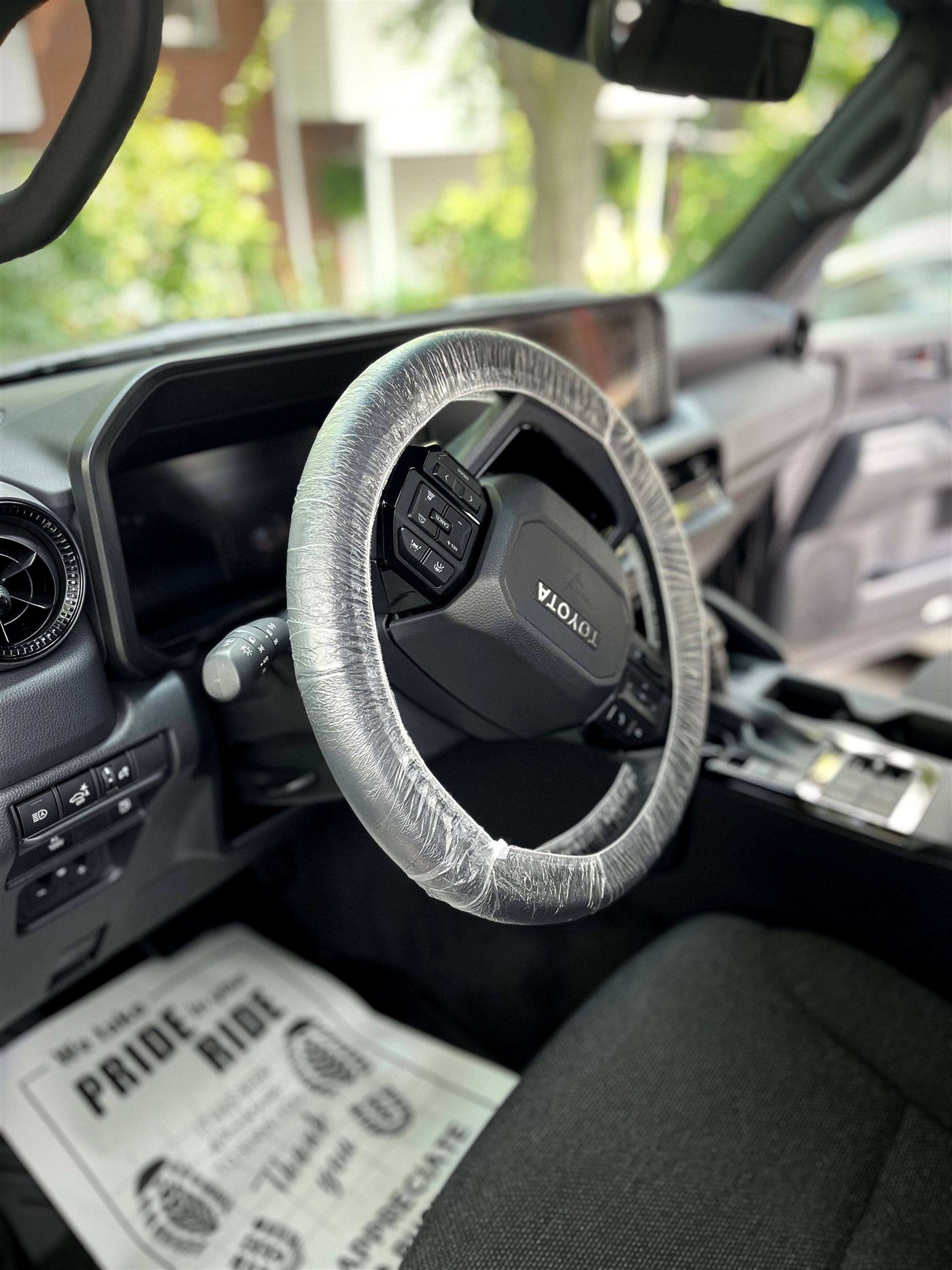 Freshly detailed Toyota interior with protected steering wheel and spotless cabin